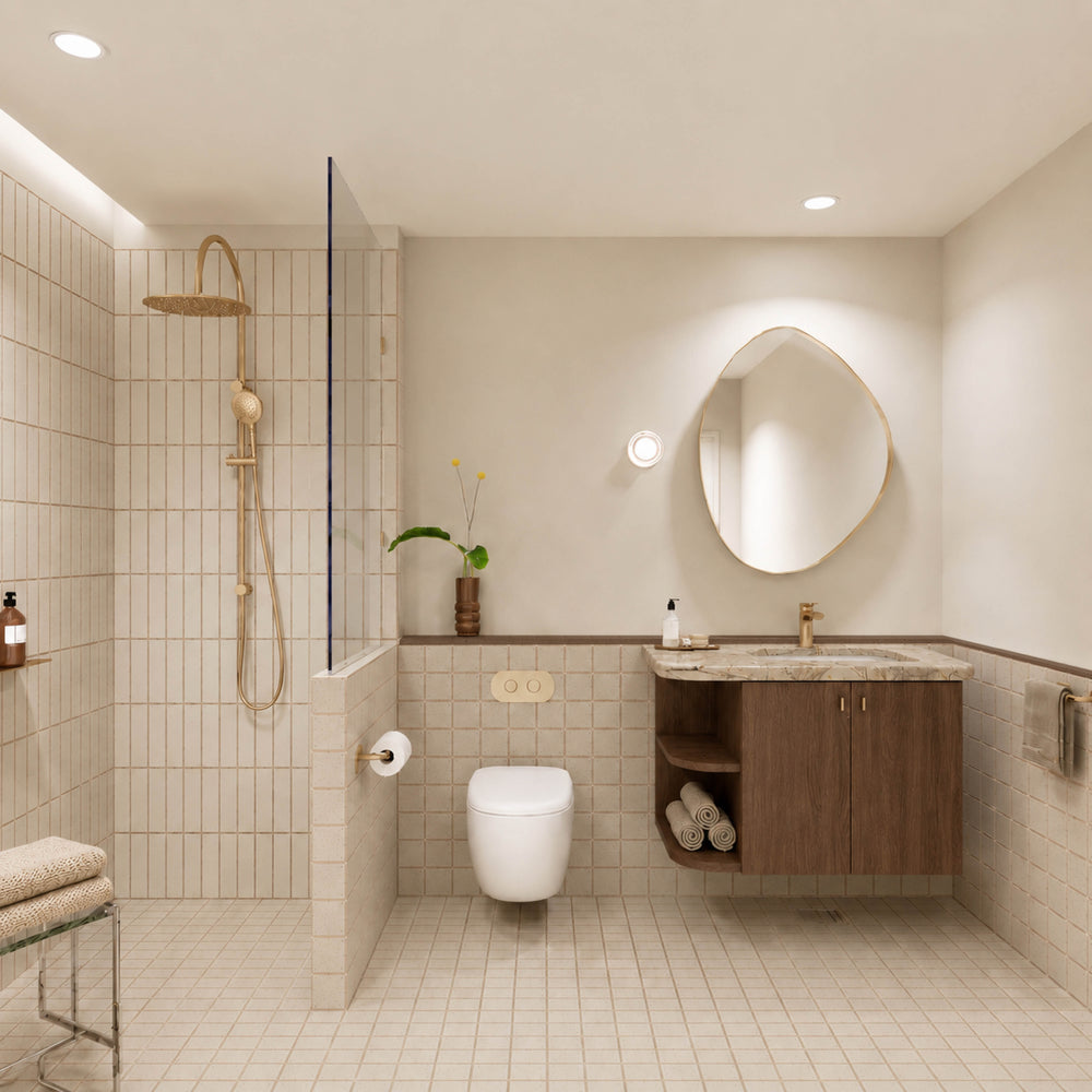 Beige tiled bathroom with walk-in shower, timber vanity, pebble-shaped mirror and gold fittings