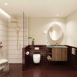 Burgundy tiled bathroom with walk-in shower, timber vanity, green stone benchtop, pebble-shaped mirror and gold fittings