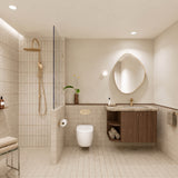 Beige tiled bathroom with walk-in shower, timber vanity, pebble-shaped mirror and gold fittings