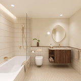 Beige tiled bathroom with shower over bath, timber vanity, pebble-shaped mirror and gold fittings