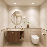 Square beige tiled bathroom with timber vanity, pebble-shaped mirror and wall-hung toilet