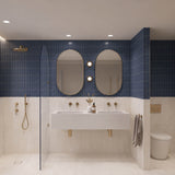 Large navy and white marble-look tiled bathroom with double white basin, two pill-shaped mirrors and walk-in shower