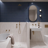 Long navy and white marble-look tiled bathroom with tiled-in bath, walk-in shower and white wall-hung basin