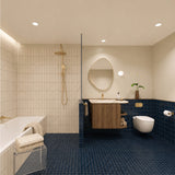 Long navy tiled bathroom with bath, walk-in shower and timber vanity with cream stone benchtop