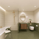 Long olive green tiled bathroom with bath, walk-in shower and timber vanity with green stone benchtop