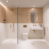 Peach and cream marble-look tiled bathroom with walk-in shower, white wall-hung basin, pill-shaped mirror and gold fittings