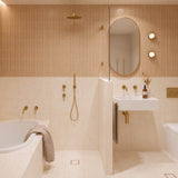 Long peach and cream marble-look tiled bathroom with tiled-in bath, walk-in shower and white wall-hung basin